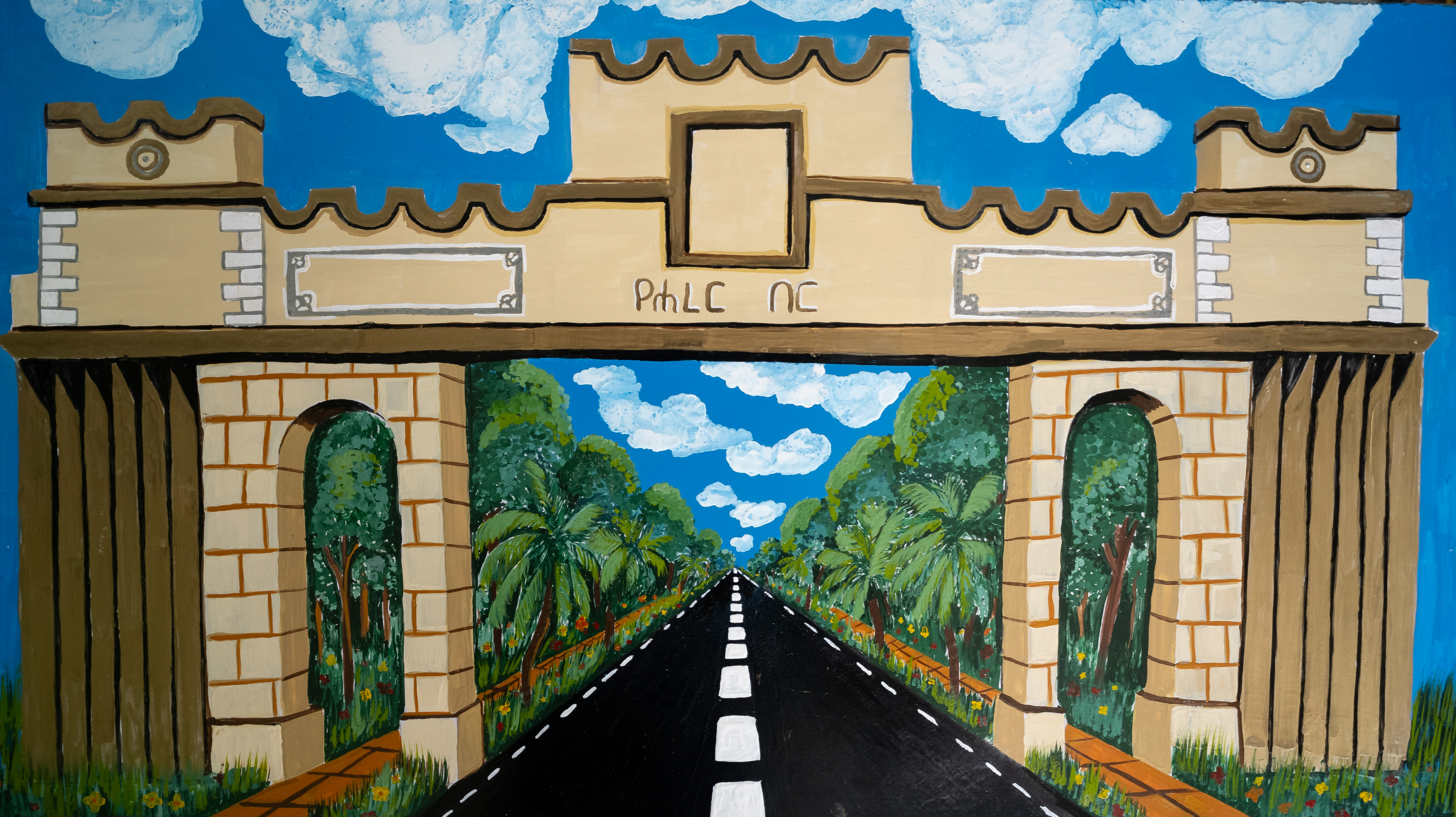 Painted architectural gateway framing a road, trees and cloud-filled sky